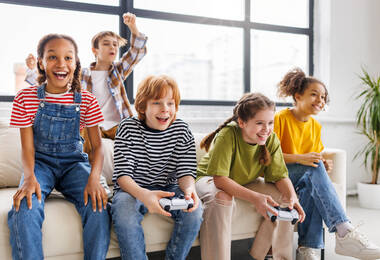5 enfants de 11 à 12 ans qui jouent ensemble à un jeu vidéo