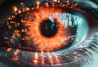 Oeil avec de la lumière rouge et des motifs rappelant le monde numérique sur la rétine